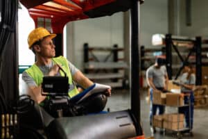 Warehouse Forklift Driver Thinking Something While Going Through Delivery Schedule Industrial Building